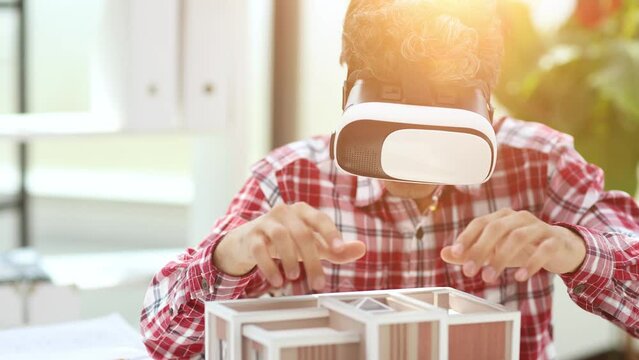 Virtual reality futuristic design technology. Architect or design engineer in VR headset for BIM technology designing a 3D model