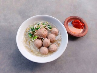 meatballs in sauce. bakso or Indonesian meatball soup with noodles. soup filled with vermicelli, meatballs and vegetables.
