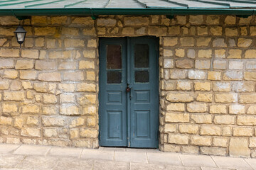 Fototapeta na wymiar Vintage green wooden door with small windows