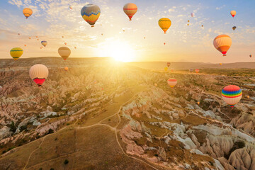 Balloons ascend in the Cappadocia sky. The radiant balloons grasp the diminishing sunlight, casting...