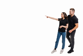 Naklejka premium A Couple Excitedly Pointing Towards an Intriguing Object. A man and a woman pointing at something