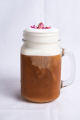 Bubble rose milk tea served in jar include chocolate and cream isolated on background side view of tea