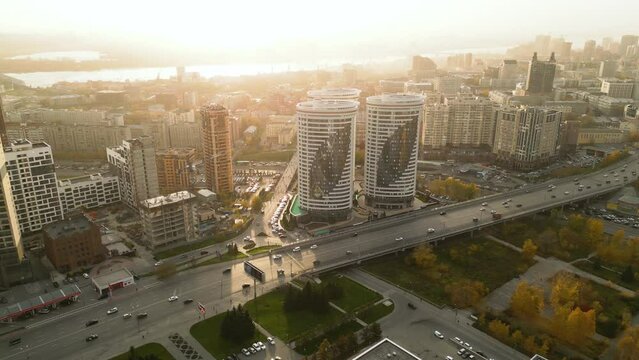 The central district of the city of Novosibirsk at sunset aerial. Modern residential complex and busy city traffic.