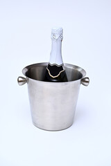 a bottle of champagne in a metal bucket on a white background
