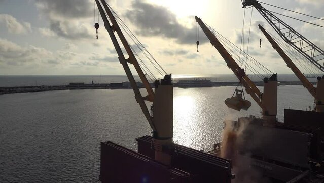 Beautiful sunset at seaport: Loading and unloading at seaport