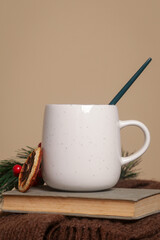 Cozy winter lifestyle concept. Cup of hot drink with vintage book and warm knitted clothes.