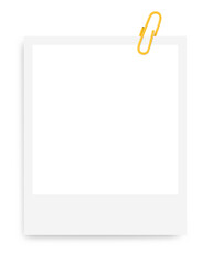 white Polaroid photo frame with a yellow paper clip on a blank background.