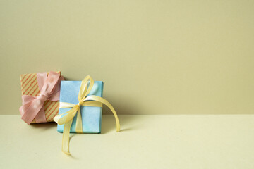 Two gift boxes on table. khaki beige background