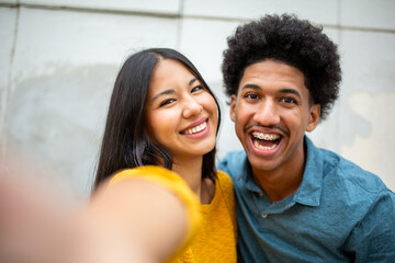 Close up smiling young couple taking selfie together