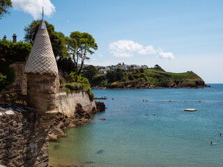 One of the trademark conical towers beside Readymoney Cove at Fowey, where the author Daphne du Maurier once lived on the south coast of Cornwall, UK. Blue sky. White clouds.