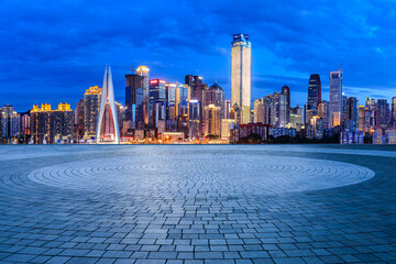 City square and skyline with modern buildings in Chongqing at night, China.