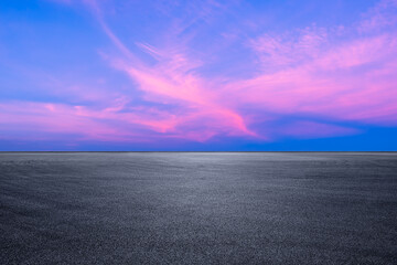 Asphalt road platform and pink sky clouds landscape at sunset - obrazy, fototapety, plakaty