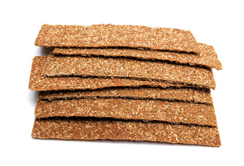 Slices of healthy low calories grain crisp bread for snack and crumbs on white background.