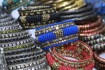 Indian bangles displayed in local shop in a market of Pune, India, These bangles are made of Gold, Silver and diamond as beauty accessories by Indian women.