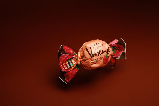 KRASNOYARSK, RUSSIA - OCTOBER 29, 2023: Chocolate candy "Varenye" on a beautiful dark red background. Elite chocolates.