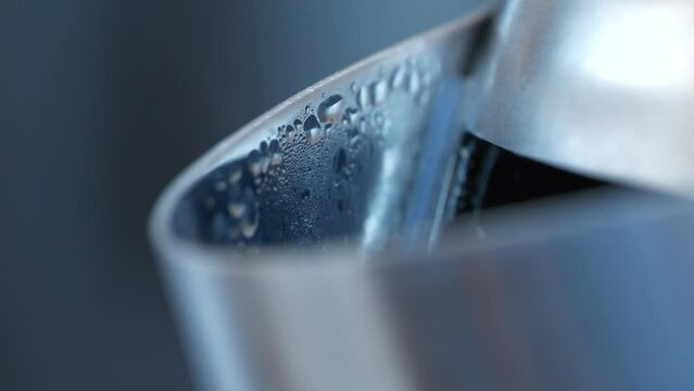 Formation of steam and condensation on the spout of the kettle