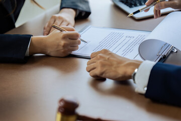 Hands of lawyer pointing at paper for businessperson signing contract. Solicitor, legal advisor...