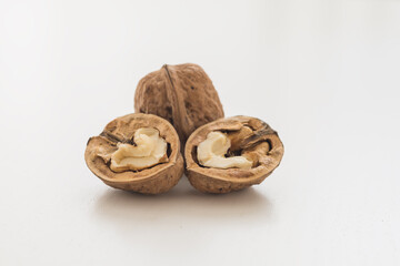 Walnuts on a white table. Pure white background.