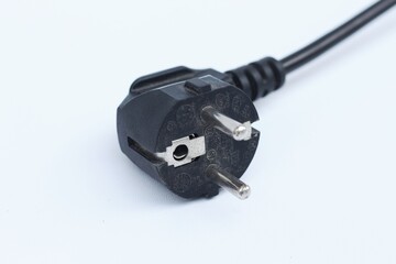 Black electric power cable with plug isolated on white background.