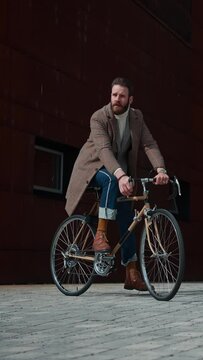  The stylish handsome man stops on a bicycle. Packshot, copyspace, hipster, worker