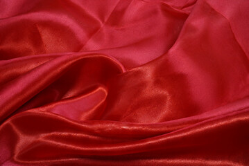 A piece red cloth. Fabric texture and design works of art, beautiful wrinkled pattern of silk or linen.