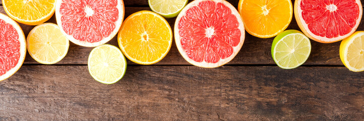 Juicy citruses on wooden table with copyspace