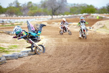 Sports, accident and man biker in a race on a dirt road in the desert with competition for hobby. Fitness, training and male athlete falling off bike and driving in a sand dune for adventure workout.
