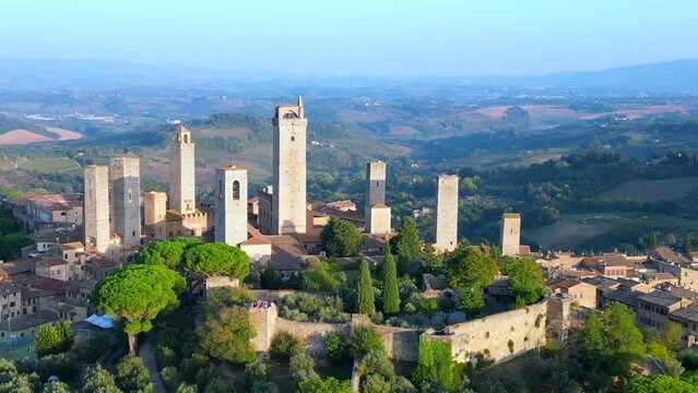 Beautiful aerial view flight drone San Gimignano hill Town sunset Tuscany Italy