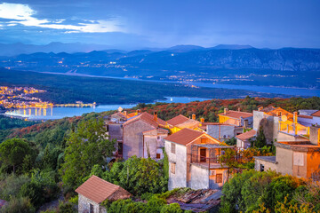 Historic town of Dobrinj and turquoise Soline bay evening view