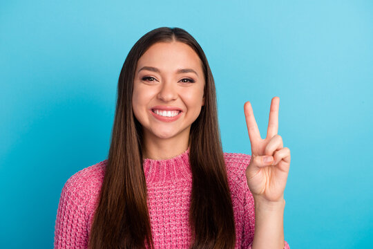 Photo of pretty adorable young lady wear striped sweater showing two v-signs cover eyes isolated blue color background