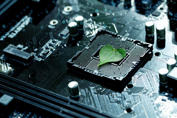 Heart shaped green leaf inside a Computer Circuit Board. Green technology and Environmental technology. Green Computing, CSR, IT ethics.Nature with Digital Convergence and Technological Convergence.