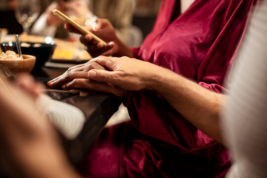 Intimate moment of hands touching during a dinner gathering