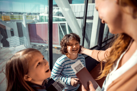 Mother and children sharing a joyful moment at the airport