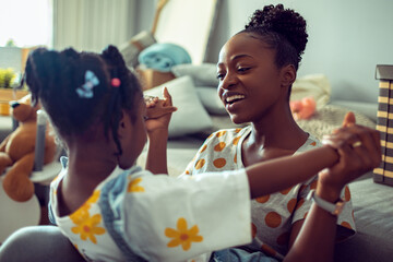Mother and daughter sharing a joyful moment at home