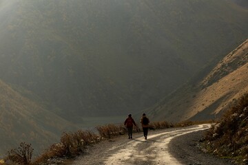Beautiful shot of people on a trail near mountains in the village of Juta, Georgia