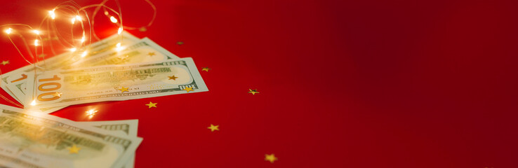 Banner for holiday card with money US dollars. Background of one hundred dollar bills. Banknotes, paper currency on red background. Concept of american and global economy, exchange rate, xmas