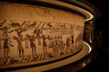 BAYEUX, FRANCE - AUGUST 25, 2022 Detail of the Bayeux Tapestry depicting the Norman invasion of England in the 11th Century - obrazy, fototapety, plakaty