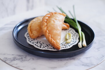 Curry puff (kari pap ) or Pastel Goreng is Pastry Popular in Indonesia.fried pastry with filling of sauted vegetable , chicken and boiled egg. accompanied with  sauce or raw chilli pepper