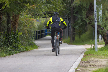 Fototapeta premium Male race cyclist driving on the road