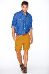 Fototapeta premium Stylish, portrait and a man or model with fashion, unique style or clothes on a white background. Cool, walking and handsome guy or person in hipster, elegant and funky clothing on a backdrop