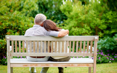 Fototapeta premium Park, back view or old couple on bench for support, trust or hope in commitment together at home. Wellness, garden or senior man bonding to relax with a mature woman on anniversary for love or care