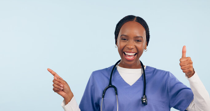 Happy black woman, portrait and doctor with thumbs up pointing in advertising against a studio background. African female person or nurse showing information, like emoji or yes sign on mockup space
