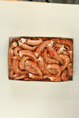 frosted king prawns closeup photo on white table background