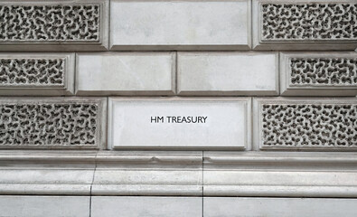 HM Treasury sign on the wall of a government building in London, UK. 