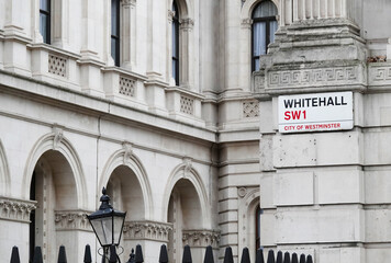 Whitehall sign on the wall of a government building at the entrance to Downing Street in Westminster, London SW1, UK. 