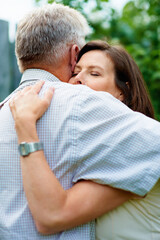 Obraz premium Senior couple, garden and a hug for commitment, care and bonding together in retirement. Comfort, elderly and a man and woman with affection, romance or loyalty in a marriage in a park for a date