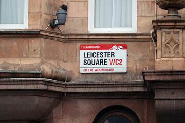 Leicester Square street sign on the wall of an old building in London WC2, UK.  