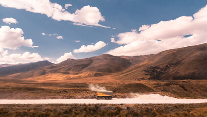 A lonely cart full of sand on a clay mine in a dusty and soft landscape, epic sky, windy day - obrazy, fototapety, plakaty
