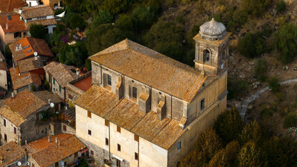 Fototapeta na wymiar Aerial view of the church of Santa Maria Assunta located in the center of the historic village of Trevignano Romano, in the metropolitan city of Rome, Lazio, Italy.