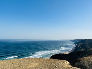 View to the ocean bay, sandy coast, view from the mountains, blue ocean horizon, pure sky
